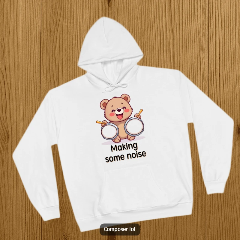 Funny and cozy hoodie depicting a bear cub with a wide grin, gleefully banging on oversized cymbals, radiating pure exuberance.